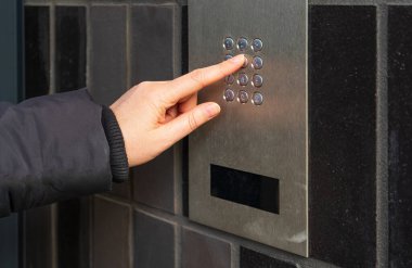 Secure Home System, Hand Pressing on Intercom Keypad, Using Door Phone, Doorphone, Entryphone, Videophone Call, Digital Electronic Doorbell