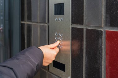 Secure Home System, Hand Pressing on Intercom Keypad, Using Door Phone, Doorphone, Entryphone, Videophone Call, Digital Electronic Doorbell