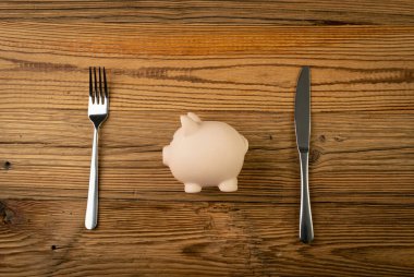 Piggy Bank on Plate, Eat Up Eating Savings, Financial Difficulties Concept, Saving Pig as Food, Eating Home Finances, Piggy Bank on Plate Top View