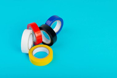 Colorful Electrical Tape, Plastic Duct Tape Rolls, Colored Adhesive Tapes on Blue Background
