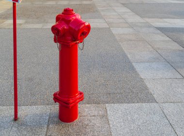 A Fire Hydrant, Waterplug, or Firecock on City Street, Red Steel Pipe to Extinguish Fires, Urban Fire-Fighting Equipment