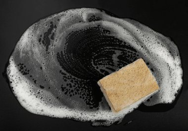 Natural Soapy Sponge with Foam, Eco Brown Sponges, Eco Friendly Hygiene Accessory, Scotch Brite Dishwasher on Black Background, Copy Space