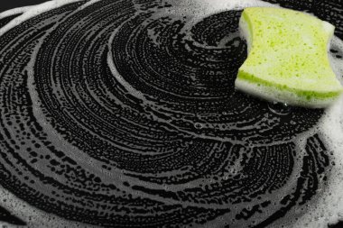 Natural Soapy Sponge with Foam, Eco Brown Sponges, Eco Friendly Hygiene Accessory, Scotch Brite Dishwasher on Black Background, Copy Space
