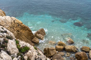 Foamy Transparent Sea Waves, Blue Clear Water on Rocky Beach Texture Background, Azure Ocean Water, Rocky Shore Pattern, Stone Shoreline, Vacation Concept