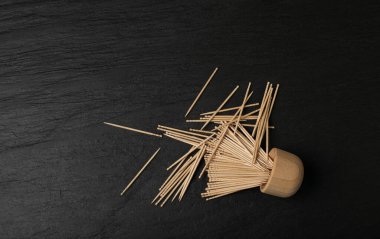 Wooden Toothpicks on Black Background with Copy Space, Flat Lay Tooth Picks, Wood Toothpicks Top View Mockup with Space for Text, Daily Dental Care Concept Banner