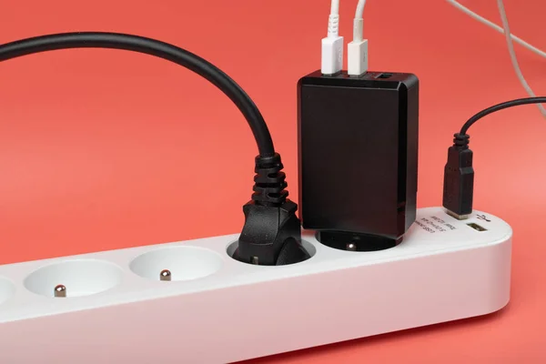 USB Plugs, Power Strip, Extension Cable, Electricity Strip USB Charging, Home Socket, Power Extender, Extension Cord on Pink Background with Copy Space