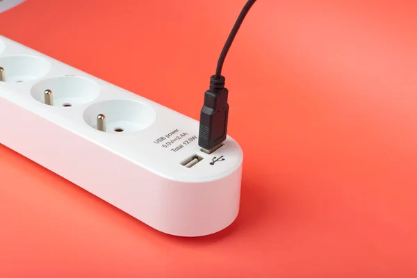 USB Plugs, Power Strip, Extension Cable, Electricity Strip USB Charging, Home Socket, Power Extender, Extension Cord on Pink Background with Copy Space