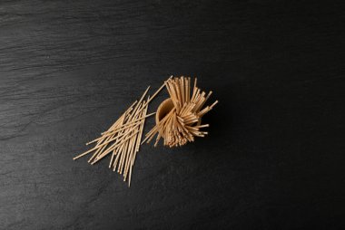 Wooden Toothpicks on Black Background with Copy Space, Flat Lay Tooth Picks, Wood Toothpicks Top View Mockup with Space for Text, Daily Dental Care Concept Banner