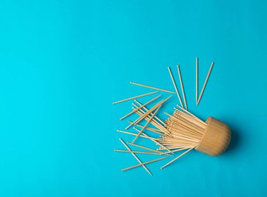 Wooden Toothpicks on Blue Background with Copy Space, Flat Lay Tooth Picks, Wood Toothpicks Top View Mockup with Space for Text, Daily Dental Care Concept Banner