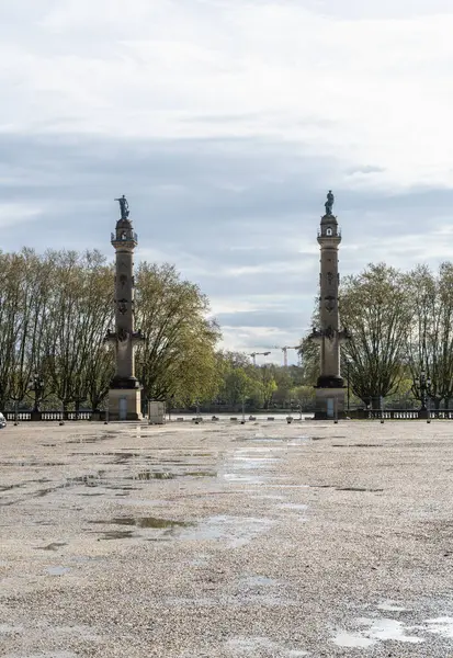 stock image Bordeaux, France, April 17, 2024: Rostral columns built by Duhamel du Monceau near garonne river, commerce and navigation symbols, historic architecture, editorial image