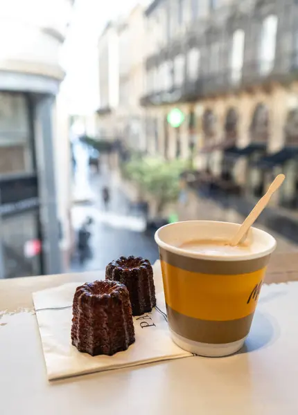 stock image Bordeaux, France, April 17, 2024: Caneles de Bordeaux in France, old historical streets, cafe view blurred background, editorial Image