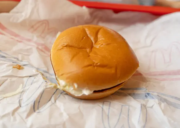 stock image Warsaw, Poland - May 2, 2024: Real mcdonald burger, authentic look, not an advertising one. Macdonalds restaurant, mac donald fast food, american burger in warsaw, popular food, editorial image