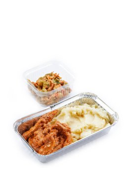 Uçaklar için tek kullanımlık beyaz arka plan plastik ve folyo sofra takımı. Atıştırmalık patates püresi ve domates soslu sebze doğranmış salata. Ekşi krema soslu.