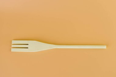 Yumuşak sarı arka planda, yeni mutfak aydınlığı, ahşap çatal şekilleri, çatallar, teflon kaplama doğal ahşap farklı kullanım türleri için spatula şekilleri bulunur.