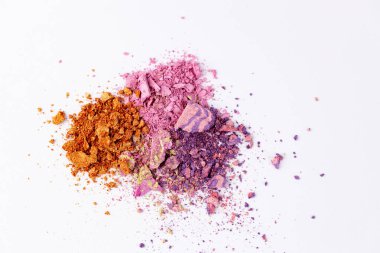 This image showcases an artistic arrangement of colorful pigment powders, including vibrant shades of orange, pink, and purple, creating a stunning visual effect against a white backdrop. clipart