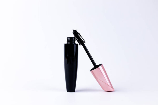 This image showcases an elegant black mascara tube with a pink cap and a brush emerging from it, perfect for applying makeup and enhancing lashes for a stunning look.