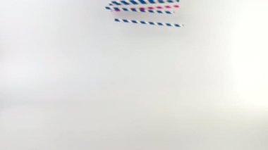 Renkli kokteyl pipetleri beyaz arka planda yuvarlanıyor. Soğuk ve sıcak içecekler için çizgili pipetler. Yaz havası. Bar ekipmanları. Sarı, pembe ve mavi. Beyaz çizgiler. Çapraz çizgiler.