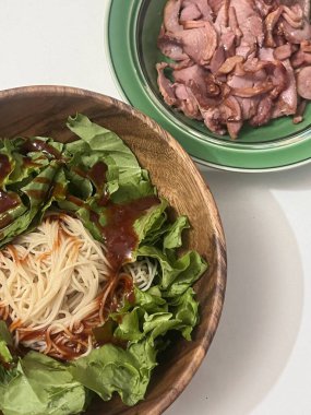 Bibimyeon, baharatlı, keskin soslu, taze sebzeli ve haşlanmış yumurtalı soğuk erişte içeren lezzetli bir Kore yemeği. Yaz yemekleri için mükemmel, canlı aromalar ve renkler sergiliyor.