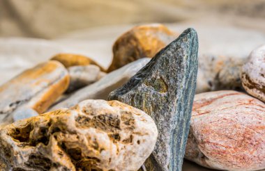 Colourful Textured Stones on a Sandy Background clipart