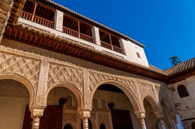 Intricate Stucco Arabic Calligraphy and Floral Motifs in Alhambras Moorish Architecture clipart