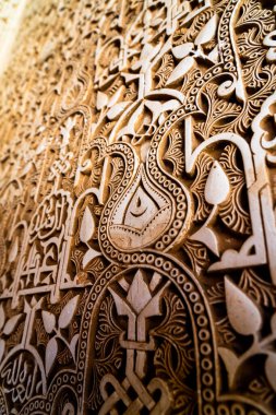 Exquisite Stucco Patterns of Alhambra Highlighting Floral Motifs and Arabic Calligraphy in a Stunning Geometric Design clipart