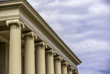 Ornate Ionic Columns Embodying Neoclassical Elegance Beneath a Subdued Sky clipart