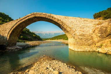 Majestic Stone Arch of Ura e Katiut Spanning Langarica Canyon in  Permet clipart