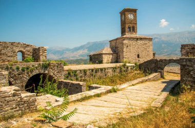 Time-Keeping Sentinel of Gjirokaster Castle: Albanias Majestic Clock Tower, Arched Stone Passages, and Historic Ramparts Overlooking the Drino Valley