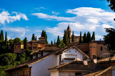 Moorish Alhambra Over Granada's Rooftops. Centuries of Nasrid Splendor Amid Verdant Andalusian Cypress Silhouettes and Timeless Spanish Heritage clipart