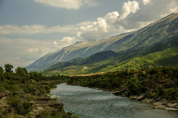 Lumi i Vjoses (Vjosa River) meanders below Mali i Nemerckes (Mount Nemrka), revealing southwestern Albania's rugged slopes and a serene Balkan vista