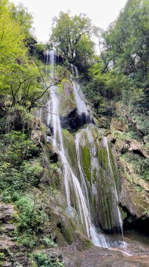 forest waterfall moss rock cascading water. Autoire, France clipart