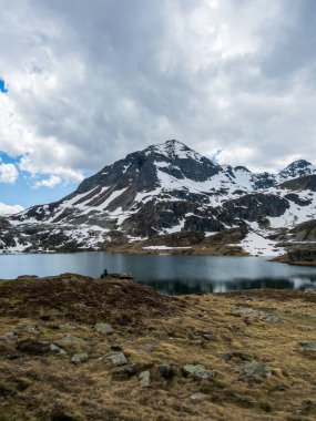 hiker enjoy peaceful solitude Fontargente lake mountain aston pyrenees clipart