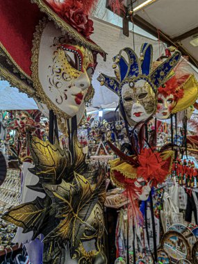 Venedik, İtalya 'da bir maske dükkanının duvarına asılmış düzinelerce renkli geleneksel maske.