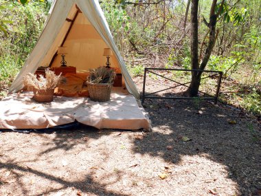 Ormanda iç mekan manzaralı beyaz bir çadır..