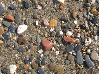 Kumsalda renkli çakıl taşları.