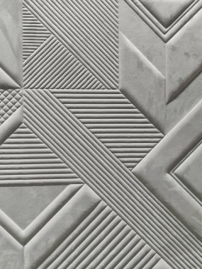 Yumuşak bej gri kumaş arkaplanda çeşitli geometri nakış desenleri.