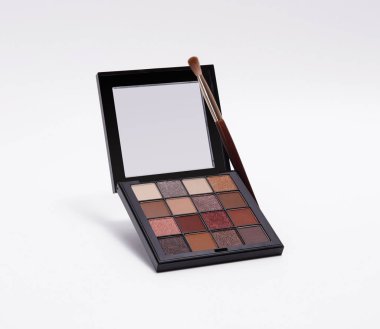 Göz falı paleti, çeşitli sıcak, nötr ve parıltılı gölgeler ve makyaj fırçası, güzellik ve kozmetik temalar için mükemmel..