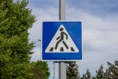 Blue and white pedestrian crossing sign 