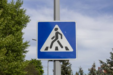 Blue and white pedestrian crossing sign 