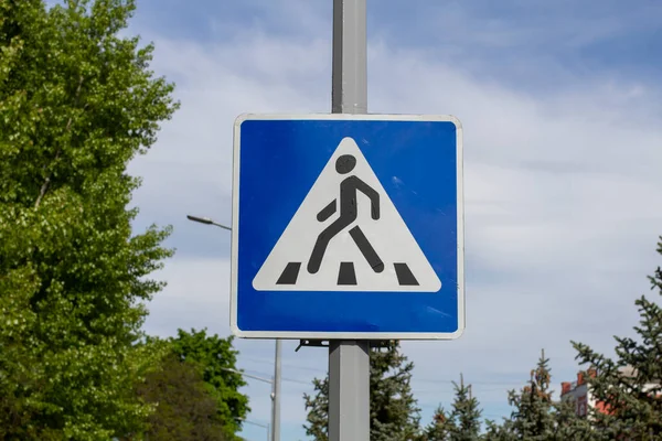 Blue and white pedestrian crossing sign