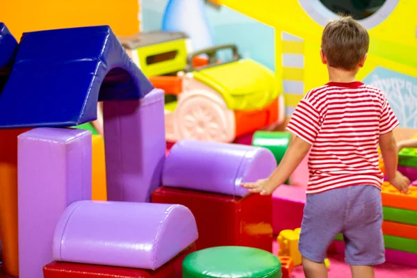 stock image Cute boy playing with building toy colorful blocks. Preschool activities and early childhood education. Kid with happy face playing with soft big blocks. Plastic Large Toy. big cubes bricks