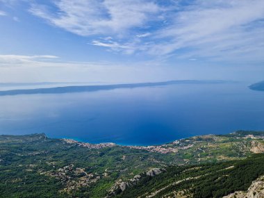 Hırvatistan 'ın Dalmaçya kentindeki Biokovo doğa parkında gökdelenden Makarska kıyı kasabasının panoramik hava manzarası