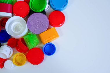 Beyaz bir yüzeye yayılmış renkli çeşitli plastik kaplamalar.