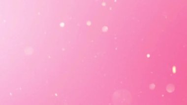 Işıldayan parçacıklar parlak pembe renkli bir arkaplana düşüyorlar.