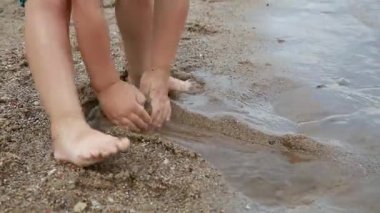 Children on summer vacation making on beach building sand castle together. kids playing with at tropical beach. enjoying playing warm sunny day on seashore. Family, Holiday and Travel concept.
