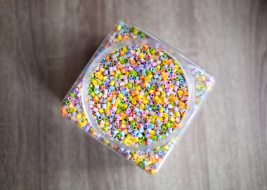 box with plastic beads in different colors of the rainbow. High quality photo