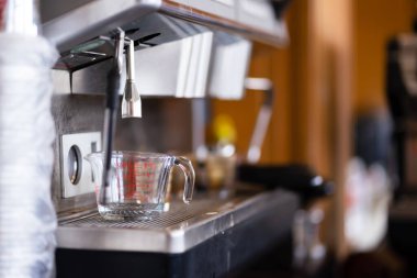 Measuring cups for brewing coffee on the coffee maker that have not been washed.