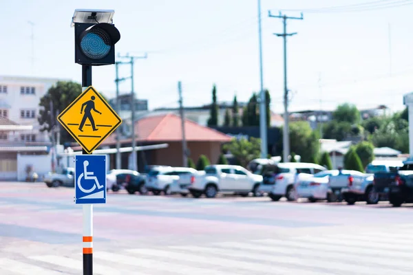 traffic signal lamp post and road crossing sign Pedestrian and wheelchair crosswalks for the disabled.