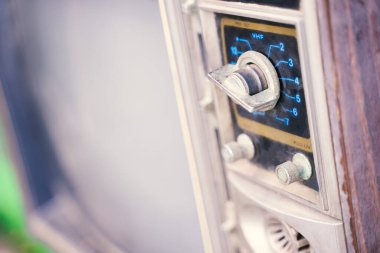 Side view of the on-off button of a retro vintage TV.