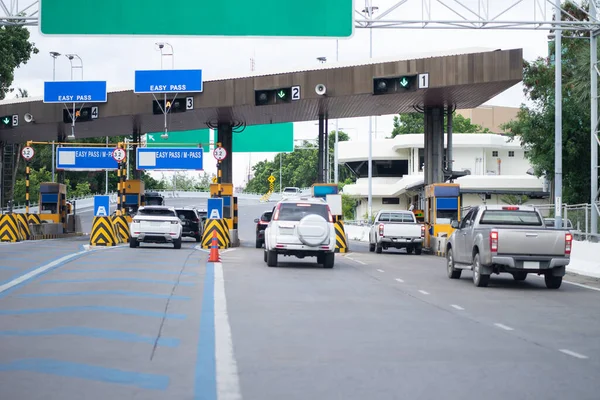 The car pays the cashier for the entrance to the motorway toll gate.